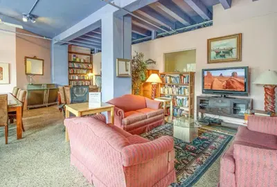 a living room with two couches and a tv at The Plaza Miami Beach in Miami Beach