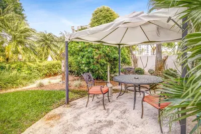 a patio with a table and an umbrella at The Plaza Miami Beach in Miami Beach