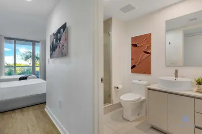 a white bathroom with a sink and a toilet at Spectacular Studio Amazing Amenities Bay View in Hallandale Beach