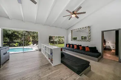 a living room with a couch and a ceiling fan at New Villa Jungle Paradise Heated Pool BBQ Soccer in Miami