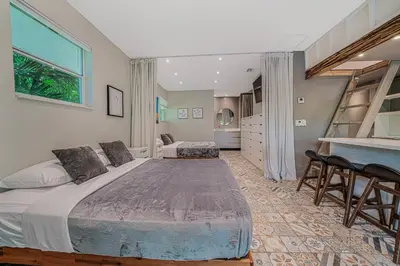 a bedroom with a large bed and a table and chairs at New Villa Jungle Paradise Heated Pool BBQ Soccer in Miami