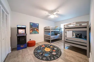 a room with two bunk beds and a video game at New Villa Jungle Paradise Heated Pool BBQ Soccer in Miami