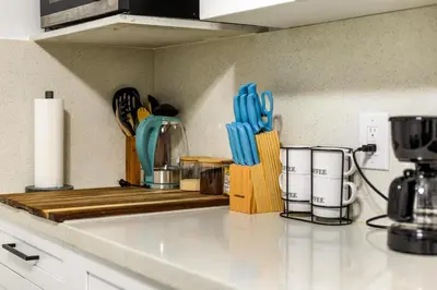 a kitchen counter with utensils on a counter top at Cozy Apartment with a luxury King Bed in Miami Gardens