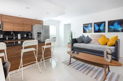 a living room with a couch and a table and chairs at GroveO6 10 minutes from the Beach in Miami
