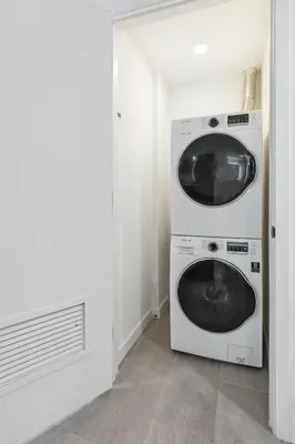 a washer and dryer in a white room at NEW Luxury Downtown Apartment - Gym Pool Workspace in Miami