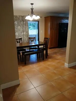 a dining room with a wooden table and chairs at Beautiful Miami Home in Miami