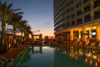 a hotel swimming pool in front of a building at Oceanfront Luxury Condo With WaterView in Hollywood