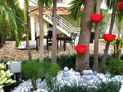 a garden with red lanterns and a table and trees at B02 5 min from beach studio Midtown Wynwood in Miami