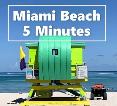 a beach life guard station on the beach with the words main beach minutes at B02 5 min from beach studio Midtown Wynwood in Miami