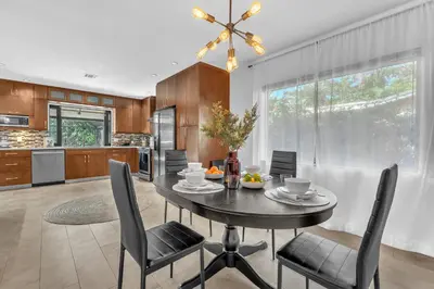 a kitchen and dining room with a table and chairs at Family Beach Home With Home Theater & Heated Pool! in Hollywood