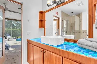 a bathroom with a sink and a mirror at Family Beach Home With Home Theater & Heated Pool! in Hollywood