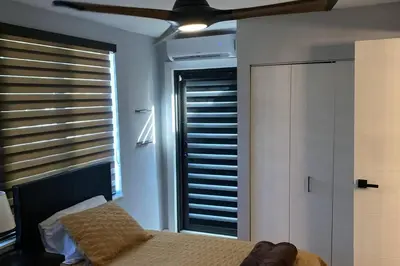 a bedroom with a bed and a window with blinds at Luxurious Westchester Home Near Miami Clinics in Miami