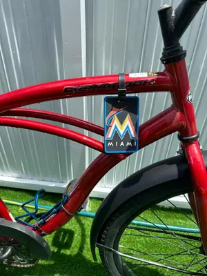 a red bike with a mavi sticker on the front wheel at Tropical Studio in Miami