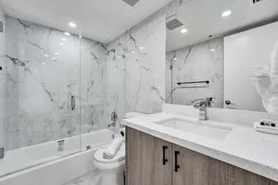 a bathroom with a sink and a toilet and a tub at Amazing 3 bedrooms 3 bathrooms Beach Resort 1518 in Miami Beach