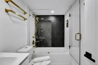 a bathroom with a tub and a toilet and a sink at Ocean View Condo Beach Service 808 in Miami Beach