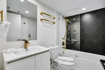 a white bathroom with a toilet and a sink at Ocean View Condo Beach Service 808 in Miami Beach