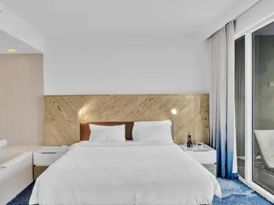 a bedroom with a large white bed and a window at FLL W Residence Penthouse, AMAZING birds eye views! in Fort Lauderdale