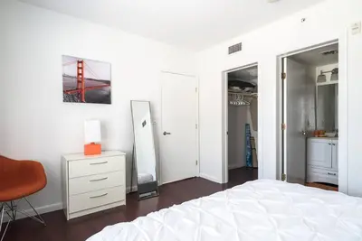 a bedroom with a bed and a dresser and a mirror at 1Bedroom Collins 2 Blocks to Ocean with Paid Street Parking in Miami Beach