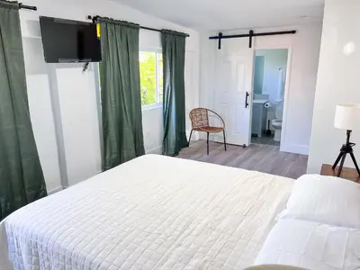 a bedroom with a white bed and a television at New 3Bedroom 2Bathroom Private Home in Miami