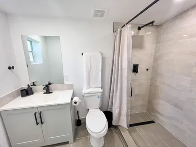 a bathroom with a toilet and a sink and a shower at New 3Bedroom 2Bathroom Private Home in Miami