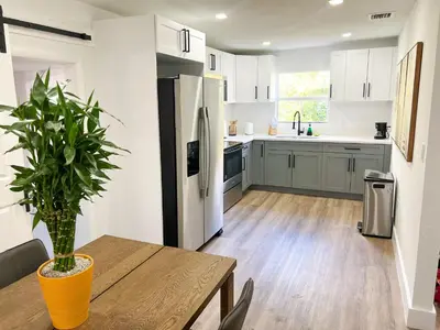 a kitchen with a wooden table with a potted plant at New 3Bedroom 2Bathroom Private Home in Miami