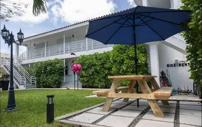 a picnic table with an umbrella in front of a building at B05 Nicest 1 bedroom APT in Midtown Miami in Miami