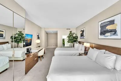 a hotel room with two beds and a desk at Double Queen Room-Hosted by Sweetstay in Miami Beach