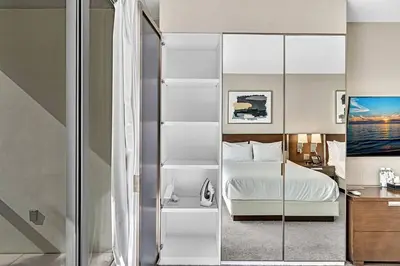 a bedroom with a white bed and a glass closet at Double Queen Room-Hosted by Sweetstay in Miami Beach