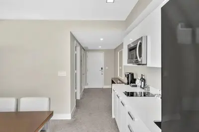 a kitchen with white counter tops and a sink at King Suite balcony water views-Hosted by Sweetstay in Miami Beach