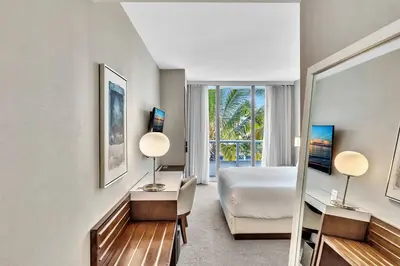 a hotel room with a bed and a window at King Suite balcony water views-Hosted by Sweetstay in Miami Beach