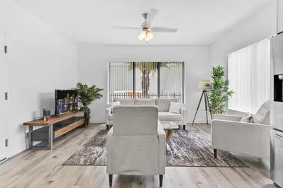 a living room with white furniture and a table at Beautiful Apt 5min walking Design District apt 1 in Miami