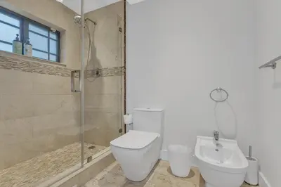 a bathroom with a toilet and a shower and a sink at Tropical Oasis with Heated Pool and BBQ in Tamiami