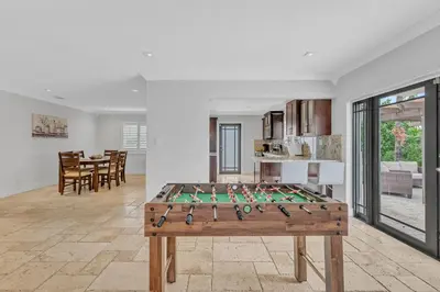 a ping pong table in a living room at Tropical Oasis with Heated Pool and BBQ in Tamiami