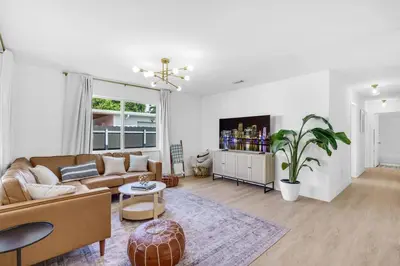 a living room with a couch and a table at Modern 3 Bedroom GetAway with Parking in Coral Gables in Miami