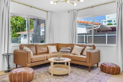 a living room with a couch and a table at Modern 3 Bedroom GetAway with Parking in Coral Gables in Miami