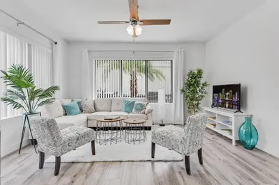 a living room with a white couch and chairs at Wonderful 6ppl Apt 5 min walking Design District 2 in Miami