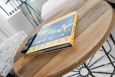 a book sitting on a table with a remote control at Wonderful 6ppl Apt 5 min walking Design District 2 in Miami