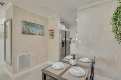 a dining room with a table and two chairs at Miami Gardens Apt 5 Miles to Hard Rock Stadium in Miami Gardens