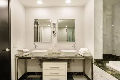 a bathroom with two sinks and a large mirror at Luxurious Stunning Views condo in Miami