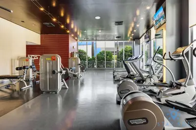 a gym with several treadmills and machines at Beautiful Studio Amazing View Balcony in Hallandale Beach
