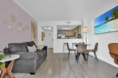 a living room with a couch and a table at Serene Cozy Retreat with Balcony Free Parking in Miami