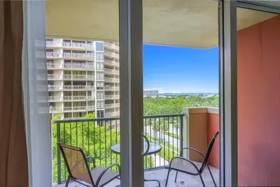 a balcony with chairs and a table with a view of a building at Serene Cozy Retreat with Balcony Free Parking in Miami