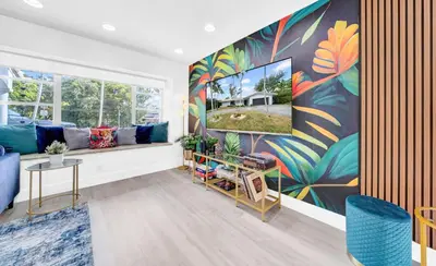 a living room with a large painting on the wall at Lakefront Retreat Perfect for Family Fun in Miami