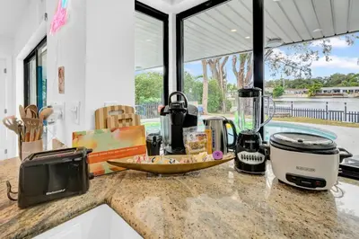 a kitchen counter with appliances on a counter top at Lakefront Retreat Perfect for Family Fun in Miami