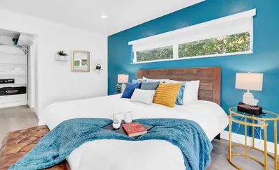 a bedroom with two beds and a blue accent wall at Lakefront Retreat Perfect for Family Fun in Miami