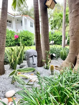 a garden with a statue in front of a house at B06 5 min from beach studio Midtown in Miami