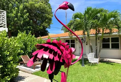 a pink bird statue in front of a house at B06 5 min from beach studio Midtown in Miami
