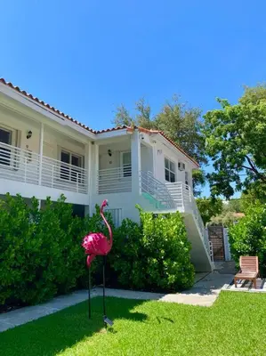 a pink flamingo standing in front of a house at B06 5 min from beach studio Midtown in Miami