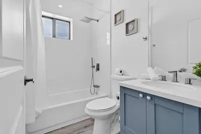 a white bathroom with a toilet and a sink at Stylish Lux Apt 5 min walking to Design District apt 7 in Miami