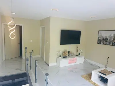 a living room with a flat screen tv on the wall at Ocean View Habana in Hialeah
